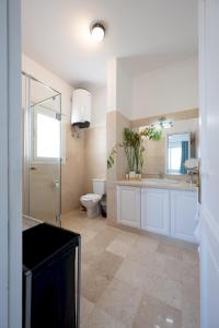 a bathroom with a shower and a toilet and a sink at VESTA - El Gouna Residence in Hurghada