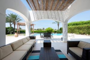 a patio with couches and a swimming pool at VESTA - El Gouna Residence in Hurghada