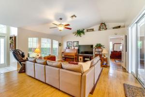 a living room with a couch and a ceiling fan at Family Home with Pet-Friendly Yard in Fort Myers! in Lehigh Acres