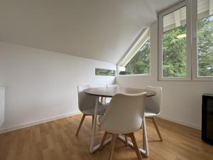 a dining room with a table and chairs at Ramoni Apartments in Hochwiese