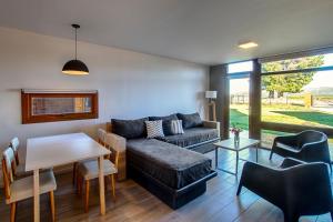 a living room with a couch and a table at Luna Llena Dina Huapi in Dina Huapi