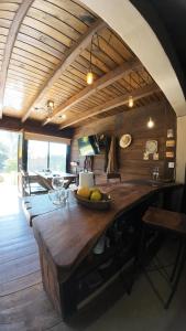 a kitchen with a wooden counter with a bowl of fruit on it at Cabaña rústica con pileta tipo playa en Salta Capital in Salta
