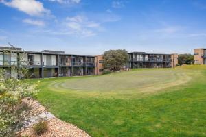 a building with a green yard in front of a building at 1BR Apartment 43 sleeps 5,Golf,Beach,Hot Springs in Fingal