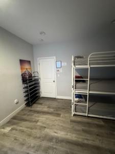 a room with three bunk beds and a door at Twin Pineapple Hostel in Los Angeles