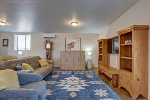 a living room with a couch and a tv at Oro Valley Guest House with Roof Top Views in Oro Valley