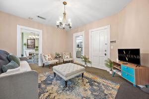 a living room with a couch and a tv at Spacious Historic House Near Louisville Sites in Louisville