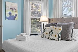 a bedroom with a bed with blue walls and a window at Spacious Historic House Near Louisville Sites in Louisville +57 photos