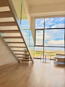 a staircase in a building with a large window at Panoramic Suites By VALENCIAFLATS EU in Valencia