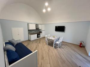 a living room with a blue couch and a table at Salvatore's Apartments in Meta