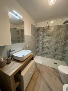 a bathroom with a sink and a toilet at Salvatore's Apartments in Meta +17 photos