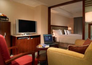a hotel room with a bed and a laptop on a table at Royal Biz Taipei Hotel in Taipei