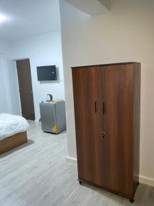 a large wooden cabinet in a room with a bed at Retaj Pyramids View in Cairo +241 photos