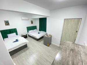 a hotel room with two beds and a mirror at Retaj Pyramids View in Cairo