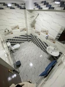 a bathroom with a sink and a toilet and a mirror at Retaj Pyramids View in Cairo +291 photos