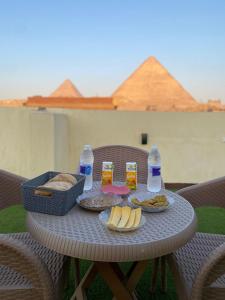 a table with food and bottles of water and snacks at Retaj Pyramids View in Cairo