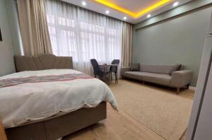 a bedroom with a bed and a couch and a table at Sleepy Taksim Hotel in Istanbul