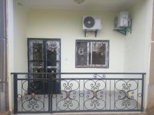 a room with two windows and a iron fence at Olympus House Meuble in Yaoundé