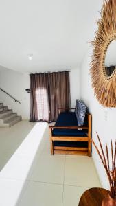 a bedroom with a bed and a mirror on the wall at Bahia Bela - Casa Duplex 02 in Santa Cruz Cabrália +17 photos