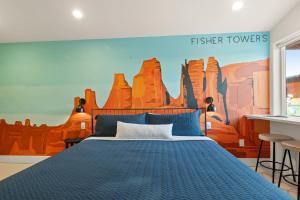 a bedroom with a bed and a mural of desert at Downtown Kokopelli # 2- Newly Remodeled Stylish Studio in Moab +22 photos