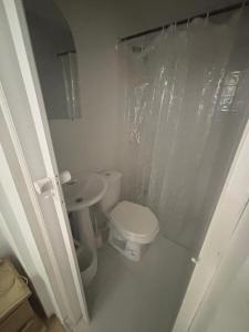 a white bathroom with a toilet and a sink at apartaestudio in Cartagena de Indias