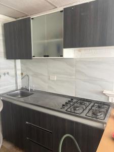 a kitchen with a stove and a sink at apartaestudio in Cartagena de Indias