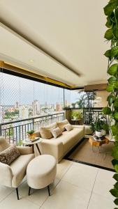 a living room with a couch and a balcony at Luxury apartment in Umarizal in Belém