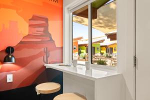 a room with a window and two stools at Downtown Kokopelli West 4 - Newly Remodeled Stylish Studio in Moab