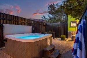 a hot tub in a backyard with a fence at Downtown Kokopelli West 4 - Newly Remodeled Stylish Studio in Moab