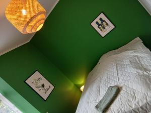 a green bedroom with a bed and a green ceiling at Danmarksgade XXL-Suites in Aalborg