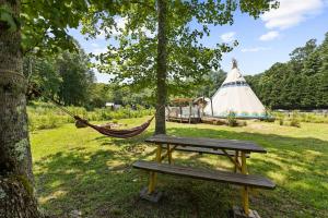 a park with a hammock and a tee pee at Lodge Apartment at Owl Creek Farm Resort in Murphy