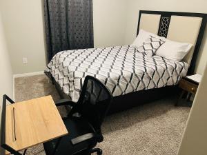 a bedroom with a bed and a desk and a chair at Private Room in Richmond, TX in Richmond