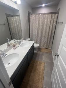a bathroom with a sink and a toilet and a shower at Private Room in Richmond, TX in Richmond +10 photos