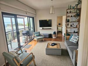 a living room with a couch and a tv at Maggie's Place in Cowes in Cowes