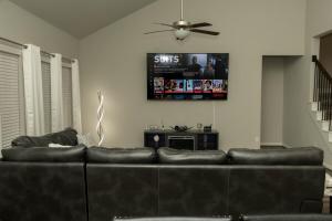 a living room with a couch and a ceiling fan at Cozy Room with Private bath in Richmond, TX in Richmond