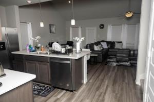 a kitchen and living room with a sink and a counter at Cozy Room with Private bath in Richmond, TX in Richmond