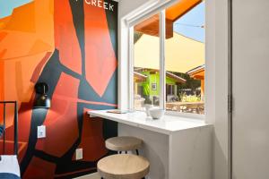 a kitchen with a counter and two stools next to a window at Downtown Kokopelli West 6 - Newly Remodeled Stylish Studio in Moab