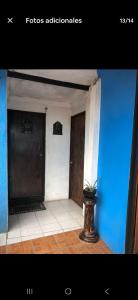 a hallway with two doors and a potted plant at CASA QUETZALCOATl in Oaxaca City