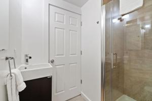 a white bathroom with a sink and a shower at RMR: Tensleep B4 Condo in Teton Village in Teton Village +9 photos