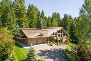 a home in the woods with a gambrel roof at RMR: Wildflower House in Teton Village in Teton Village