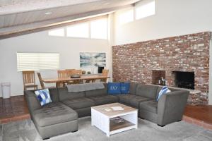 a living room with a couch and a brick fireplace at Ocean Blue in Oxnard