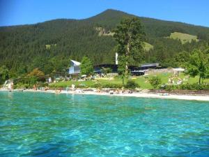 a beach with a group of people in the water at One-bedroom apartment in Oberammergau