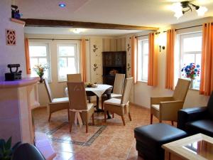 a living room with a dining room table and chairs at Holiday home Bauernhauschen in the Rhon in Bernshausen