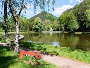a plastic animal statue in front of a lake at Lakefront Glamping w Pets in Herpelmont