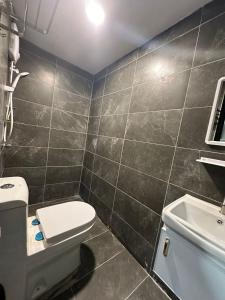 a bathroom with a toilet and a sink at SS GREY INN Bb in Kuala Lumpur