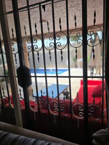 a window with raindrops on a wrought iron fence at Floor Villa rent in El Harhoura