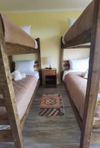 a bedroom with two bunk beds and a table at Refugio Lo Más visto in San Antonio +28 photos