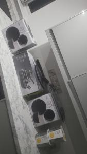 two boxes are sitting on top of a refrigerator at Cedar Townhouse in Wibsey