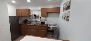 a kitchen with wooden cabinets and a stove top oven at Blue Serenity in Georgetown