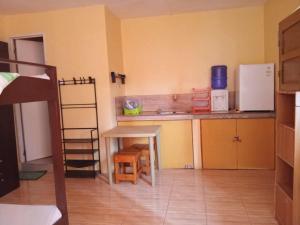 a kitchen with a small table and a refrigerator at BM Island Inn in Bantayan Island