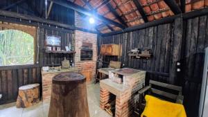 a room with a stove in a wooden cabin at Sítio Canto do Monte in Rolante